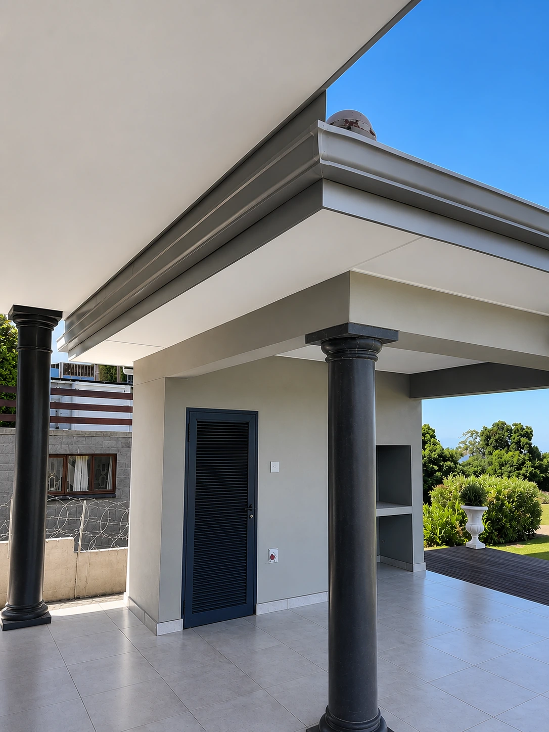 Fascia, gutter and downpipe detail above a covered patio